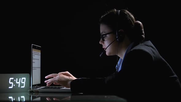 Female Call-Center Employee in Formal Suit and Headphones Working at Night Shift
