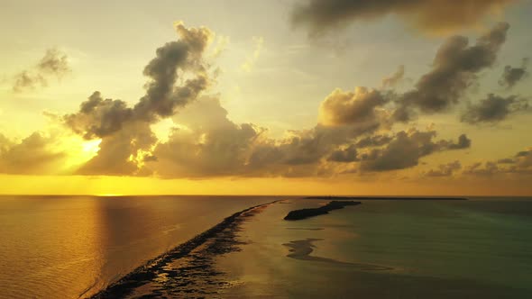 Daytime birds eye clean view of a white paradise beach and blue sea background in hi res 4K