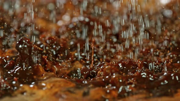 Super Slow Motion Macro Shot of Splashing Fresh Coffee and Water Droplets at 1000 Fps