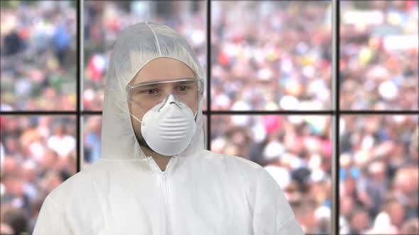 Portrait of a Guy Wearing White Respiratory Mask and Protective Suit