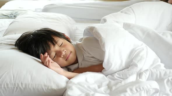 Cute Asian Child Sleeping  On White Bed Slow Motion