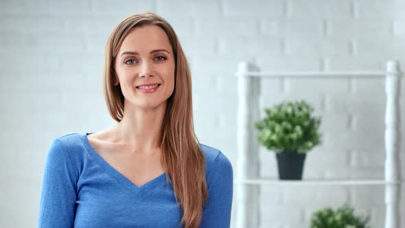 Portrait of Casual Woman Smiling Posing White Room Interior