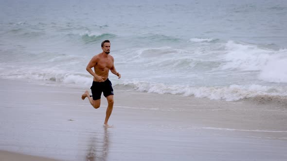 Athletic Man Exercising At The  Beach