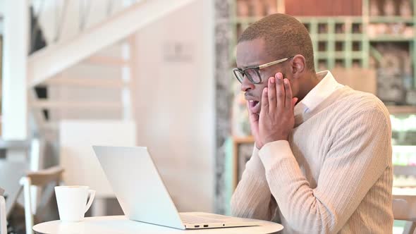 Loss African Man Reacting to Failure on Laptop in Cafe