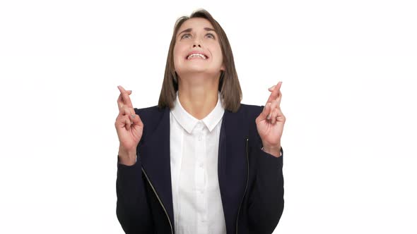 Portrait of Goodlooking Female Office Worker Wishing for Good Luck Looking Up with Closed Eyes and