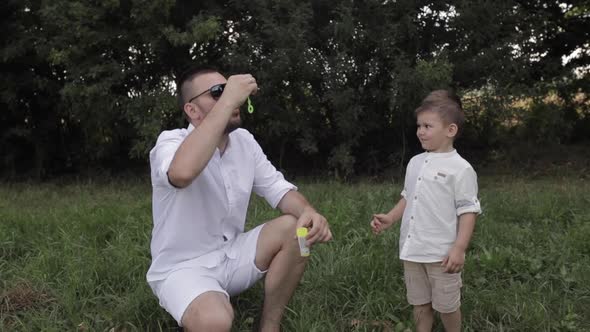 Father and His Son Making Soap Bubbles.