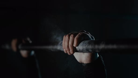 Slow Motion Closeup Hands Men Hanging on Horizontal Bar with Magnesia in Gym