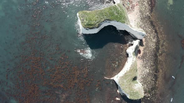 Slow rising drone shot of Old Harry Rocks chalk cliffs in the UK