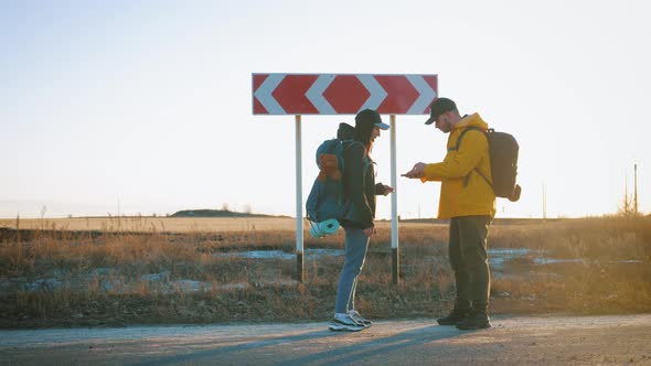 Young Tourists Couple Arguing About Best Path for Hiking Pointing and Choosing Right Direction