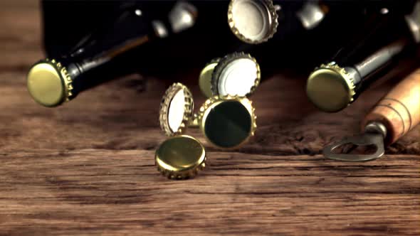 Super Slow Motion Beer Lids Fall on the Table and Rotate