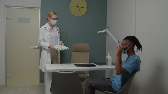 Female Doctor and Man Wearing Mask for Protection Against Coronavirus