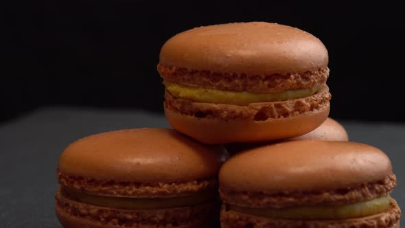 Macaroon Candy Rotate on a Black Surface for Background Sweets are Spinning Macro