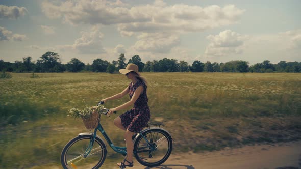 Lady Cycling. Woman With Blonde Hair Cycling. Beautiful Girl Hat. Happy Beautiful Girl With Bike.