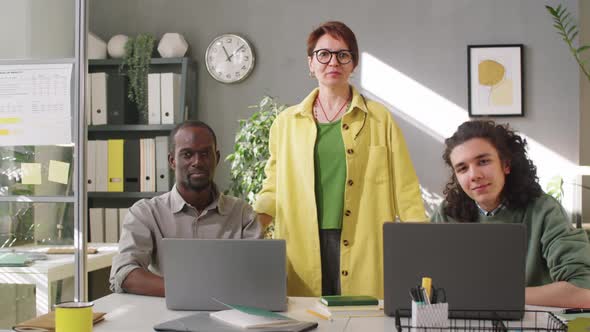 Portrait of Female Business Mentor and Multiethnic Male Trainees