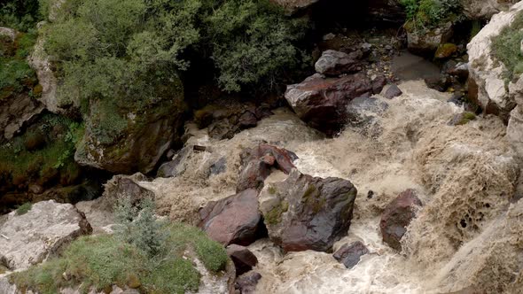 Stormy Mountain River with Stones and Mud in Summer