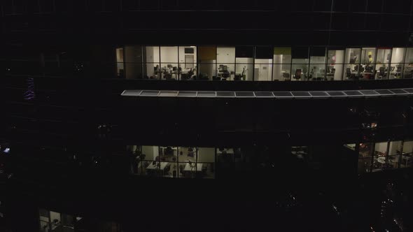 Aerial View From Drone on Glass Facade of Modern Skyscraper with Offices at Night