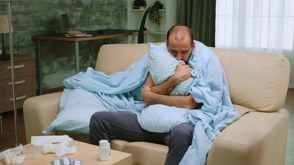 Man with Chills on Sofa