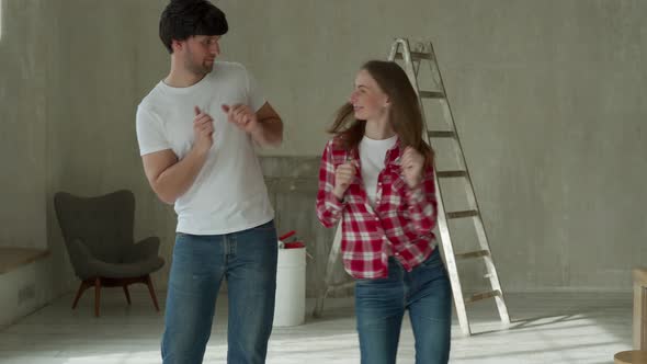 Young Couple Home Repair Singing and Dancing