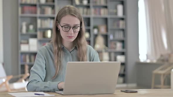 Portrait of Serious Woman Working on Laptop