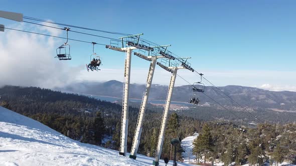 Ski lift brings people up Big Bear mountain with a beautiful view.