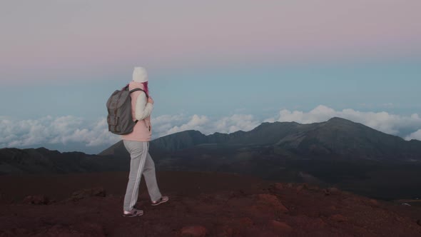 Woman Enjoying Cinematic Clouds on Background at Pink Sunset Over Volcano Maui
