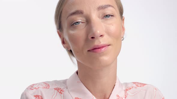 Woman Portrait in Studio on White. Healthy Shiny Skin with First Wrinkles