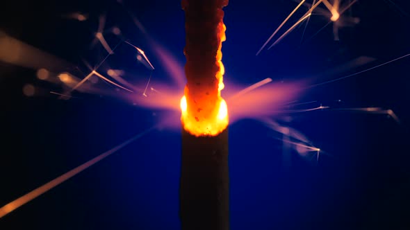 Sparkler Over Violet. Gun powder sparks shot against deep dark background.