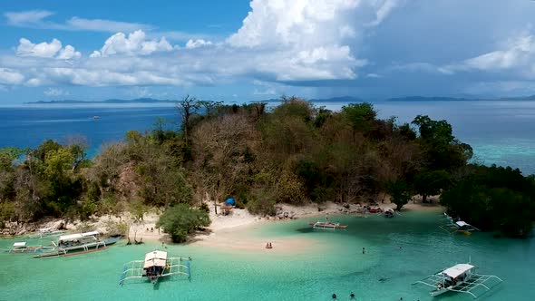 Aerial establishing shot of CYC beach on CYC Island, Coron town, Philippines