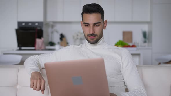 Portrait of Overburdened Middle Eastern Handsome Man Closing Laptop Sighing and Rubbing Face