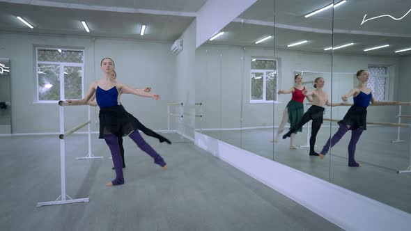 Front View Three Confident Talented Ballerinas Rehearsing Leg Up in Fifth Position Turning Repeating