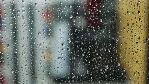 Raindrops run down the window pane on a rainy day