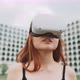 A woman moving her head while using augmented reality goggles - VideoHive Item for Sale