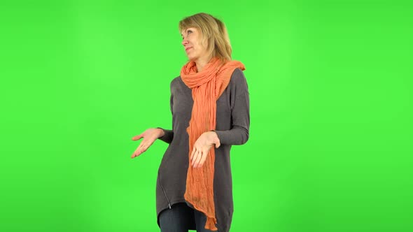 Middle Aged Blonde Woman Is Surprised at What Is Happening Around. Green Screen