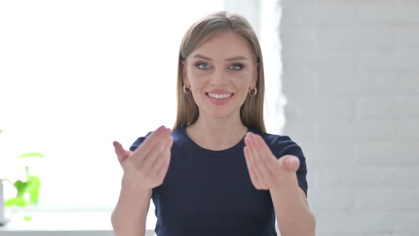 Portrait of Woman Pointing at the Camera and Inviting