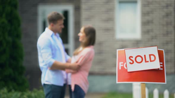 Cute Couple Hugging and Smiling, Celebrating Purchase of Great House, Signboard