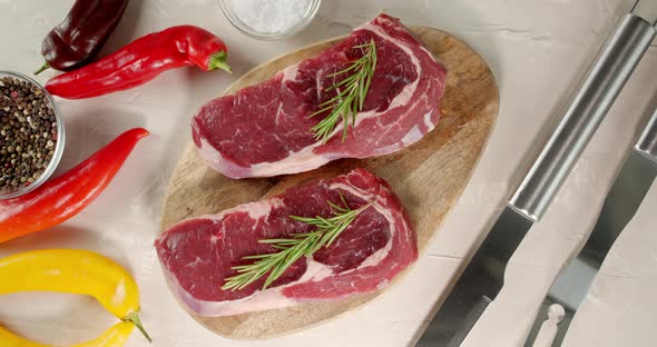 Steaks Raw Beef Ribeye on a Wooden Cutting Board. 