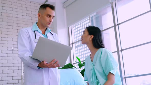 Doctor in Professional Uniform Examining Patient at Hospital