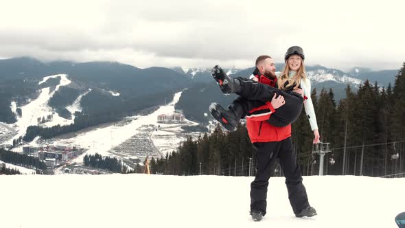 Loving Couple in Sporty Wearing on Mountain at Ski Resort