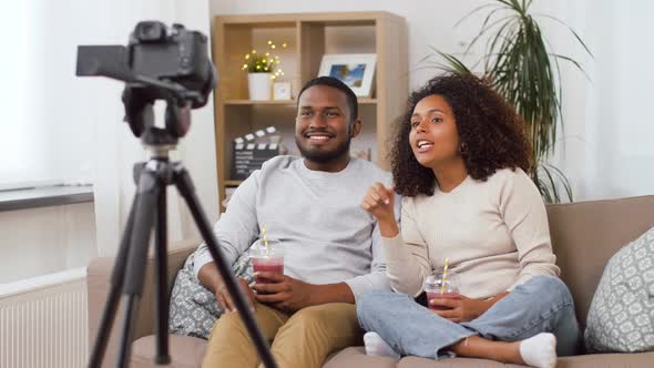 Couple of Video Bloggers with Camera at Home