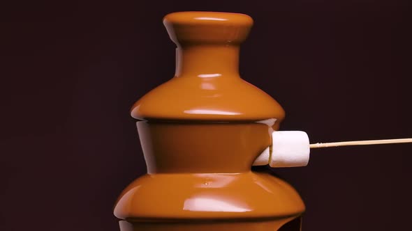 Melted Milk Chocolate Flows in Chocolate Fountain