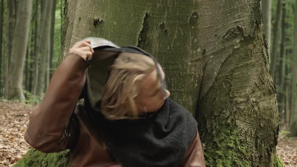 Exhausted warrior taking off his helmet