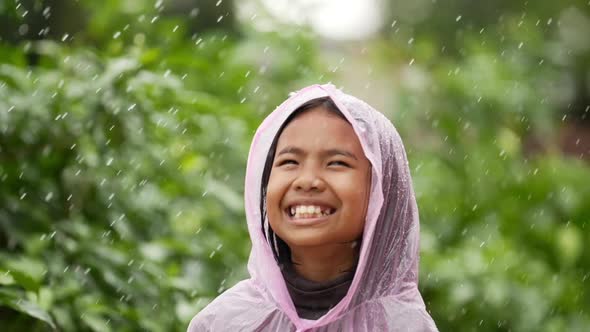 Happy girl wears raincoat