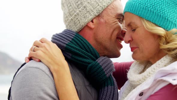 Senior man kissing senior woman on cheeks