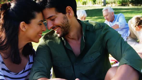 Romantic couple sitting in park