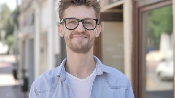 Gesture of Yes by Outdoor Standing Young Man