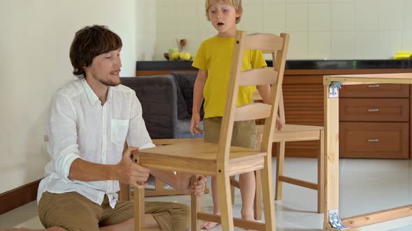 Father and Son Assemble Wooden Furniture From Small Parts. After Finishing a Chair Assemble Man Puts
