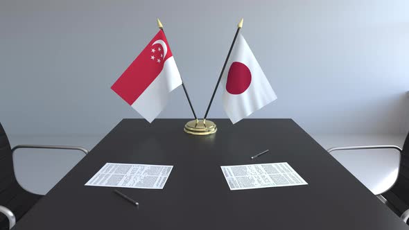 Flags of Singapore and Japan on the Table