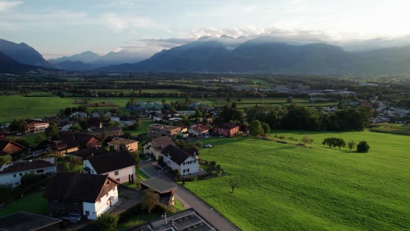 Aerial View of Liechtenstein with Houses on Green Fields in Alps Mountain Valley