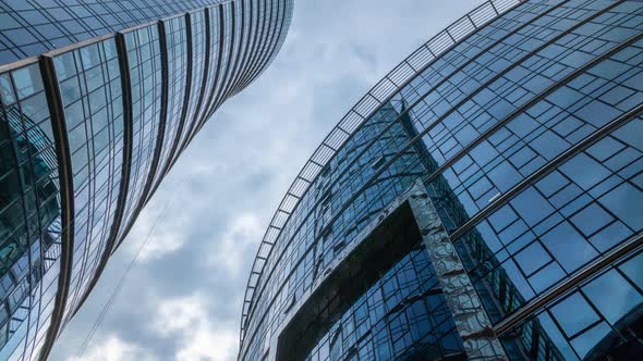 Timelapse Skyscrapers High Office Buildings Facades Blue Sky and Clouds Moving Fast in Timelapse