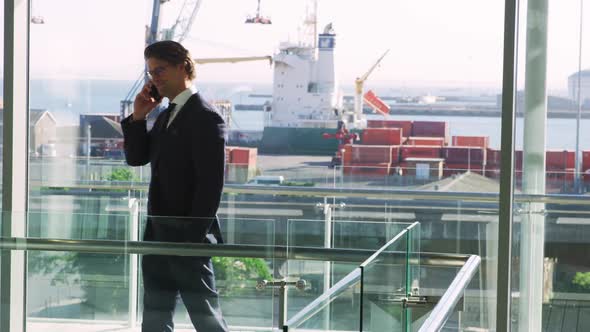 Buisnessman using smartphone in modern office building